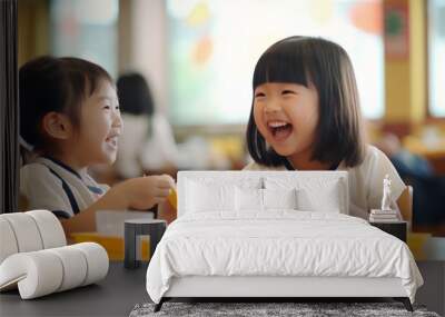 Two Asian elementary school students joyfully sharing a meal together, their faces beaming with happiness and laughter Wall mural