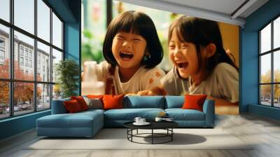 Two Asian elementary school students joyfully sharing a meal together, their faces beaming with happiness and laughter Wall mural