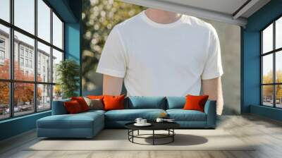 Vertical portrait of a young blond caucasian man wearing a blank white mockup t-shirt with copy space Wall mural