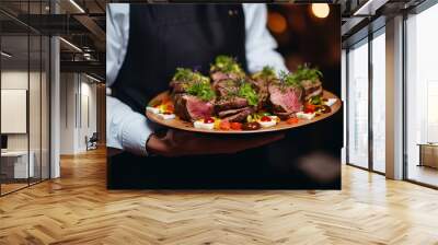 Waiter carrying plates with meat dish on some festive event, party or wedding reception restaurant Wall mural