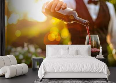 Waiter pouring a glass of red wine into a wine glass Wall mural