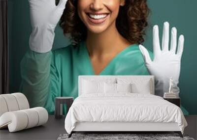 Woman nurse smiling rising her two hands in the air Wall mural