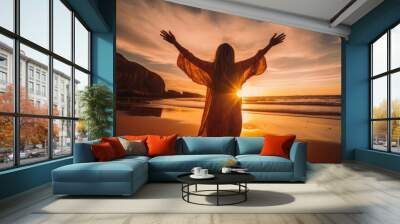 Woman on the beach worshiping the Sun at sunset with dramatic light Wall mural