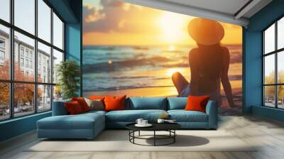 Woman with hat vacationing at sunrise at the beach looking at the ocean with Copy Space , summer holiday background image Wall mural