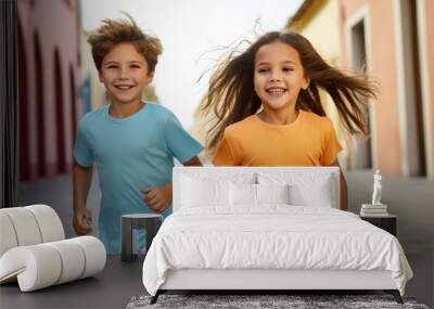 Young boy kid and girl model cheerful playing running together wearing colorful empty blank t-shirt Wall mural