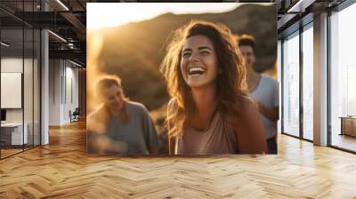 Young woman leading a group of people in laughter yoga session on a mountaintop at sunrise, their laughter echoes through the serene landscape as they embrace the healing power of laughter and nature Wall mural