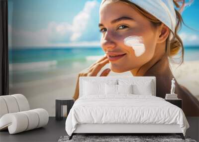 Young woman spreading sunscreen on her face to protect against sun light with sunblock Wall mural