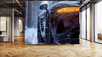 Close-up of the wheels of a car with winter tires on a snowy road in the forest Wall mural