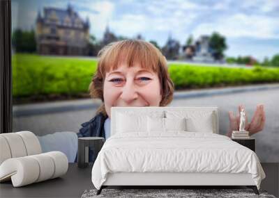 A woman enjoys her travel adventure at Garibaldi Castle, showcasing her excitement in a historic setting. The adventures of a middle-aged female tourist on a trip Wall mural