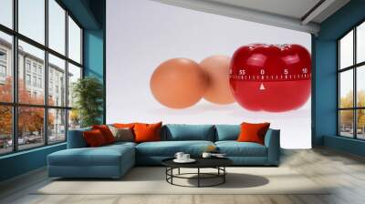 Egg timer mockup in the form of a tomato with two eggs Wall mural