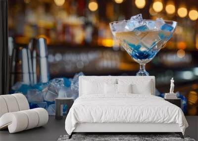 Diamond-shaped blue and white ice cubes piled on the bar table, with a cocktail, creating a stylish and refreshing bar scene Wall mural