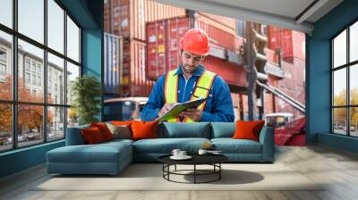 Male Industrial Engineer in White Hard Hat checking container at container yard warehouse. Logistics business. Wall mural