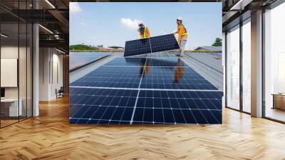 Men technicians carrying photovoltaic solar moduls on roof of factory on the morning. Installing a Solar Cell on a Roof. Solar panels on roof. Workers installing solar cell power plant eco technology. Wall mural