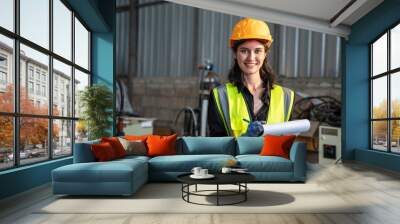 Portrait of female automation engineer standing and looking camera in industrial factory.  Wall mural