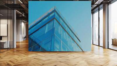 Modern glass building with clear blue sky above, showcasing sleek architecture Wall mural