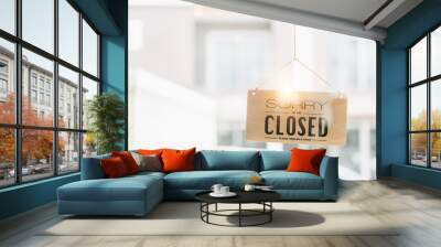 Closed sign hanging in window, indicating business is not open Wall mural