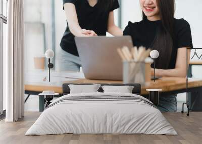 Collaborative work environment with two women at laptop Wall mural