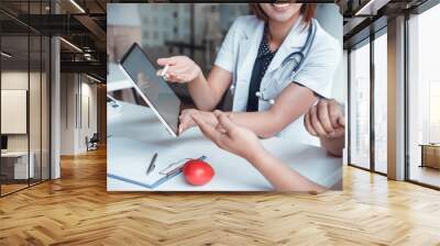 Professional doctor reporting medical results on mockup tablet white screen to male patient at clinic.Diagnostic, prevention of men diseases, medical service, consultation, Medical technology concept. Wall mural