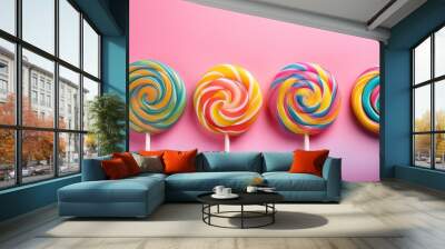 three swirly lollipops with vibrant colors positioned in a row on a blend of pink background symbolizing sweetness fun and childhood memories in a playful setting Wall mural