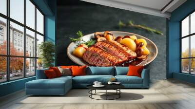 there is a plate of meat and potatoes on a table. Wall mural