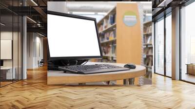 Computer with blank screen monitor on table in interior school library Wall mural