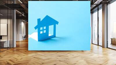 Concept of house in paper on blue color background for real estate property industry Wall mural