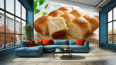 Freshly baked golden brown dinner rolls bread served on wooden board Wall mural