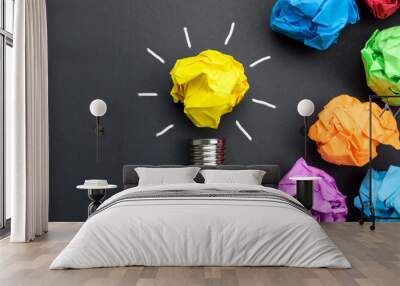 Great idea concept with crumpled colorful paper and light bulb on black background Wall mural