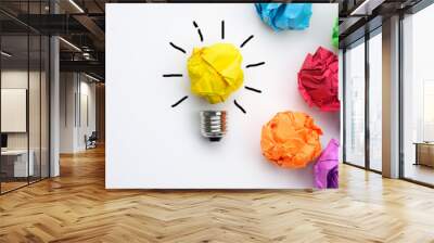 Great idea concept with crumpled colorful paper and light bulb on white background Wall mural