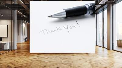 Hand writing thank you note on a piece of white paper Wall mural