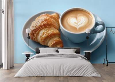 Cup of coffee and freshly baked croissants on a heart-shaped plate on a blue background Wall mural