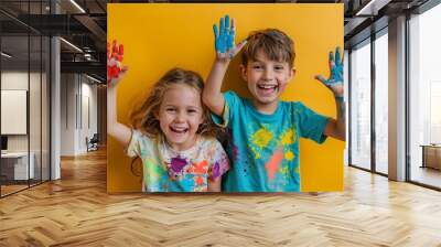 Portrait of happy kids with finger colours and painted t-shirts Wall mural