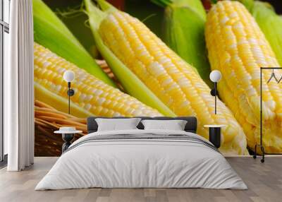 Sweetcorn offering, husked and unhusked ears in a basket Wall mural