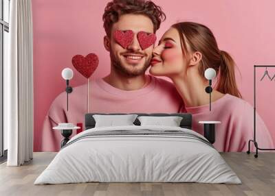 Romantic couple embraces valentine's theme with love hearts and pink attire Wall mural