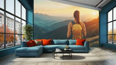 woman with yellow backpack enjoys breathtaking sunset view over mountainous landscape, surrounded by lush greenery and distant peaks. scene evokes sense of adventure and tranquility Wall mural