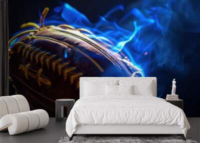 Close-up of a softball glove catching the ball with a hint of blue flame for dramatic effect. Wall mural