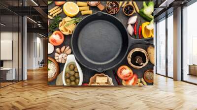 Italian food cooking ingredients on dark stone background with  cast iron pan flat lay and copy space. Wall mural