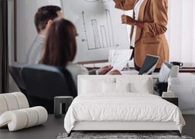 Businesswoman giving presentation to her colleagues Wall mural