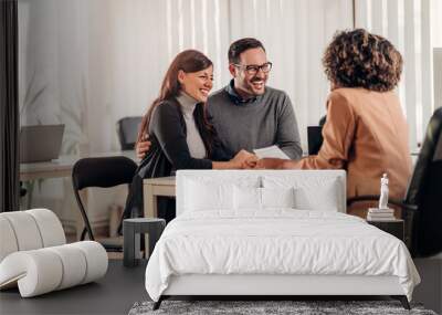 Couple talking to their insurance agent on a meeting Wall mural