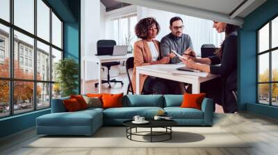 Couple talking to their insurance agent on a meeting Wall mural