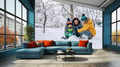 Family playing in the snow Wall mural