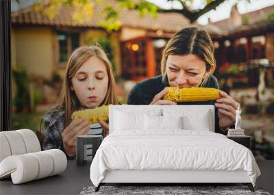 girls eating sweet corn outdoor Wall mural