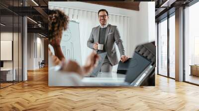 Happy cheerful businessman drinking coffee on the meeting Wall mural