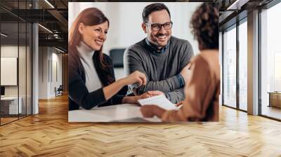 Happy couple talking with sales manager Wall mural