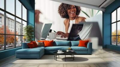 Portrait of cheerful young businesswoman laughing at the meeting Wall mural