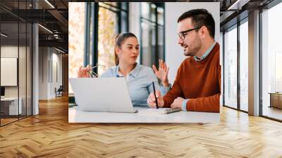 Two young businesspeople working together Wall mural