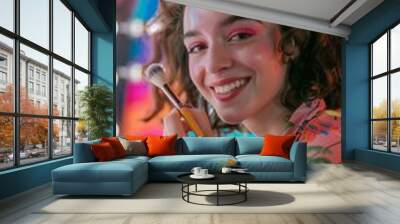 A cheerful makeup artist applying makeup against a backdrop of colorful cosmetics and brushes. Wall mural