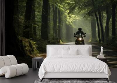 A motorcycle enthusiast enjoying the serenity of a forest road Wall mural