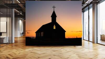 Simple silhouette of a church building with a cross on top, conveying the essence of Christian worship Wall mural