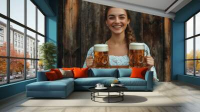 Close-up photo of a woman in dirndl, traditional festival dress, holding two mugs of beer in her hands. Oktoberfest, St. Patrick’s day, international beer day concept. Wall mural